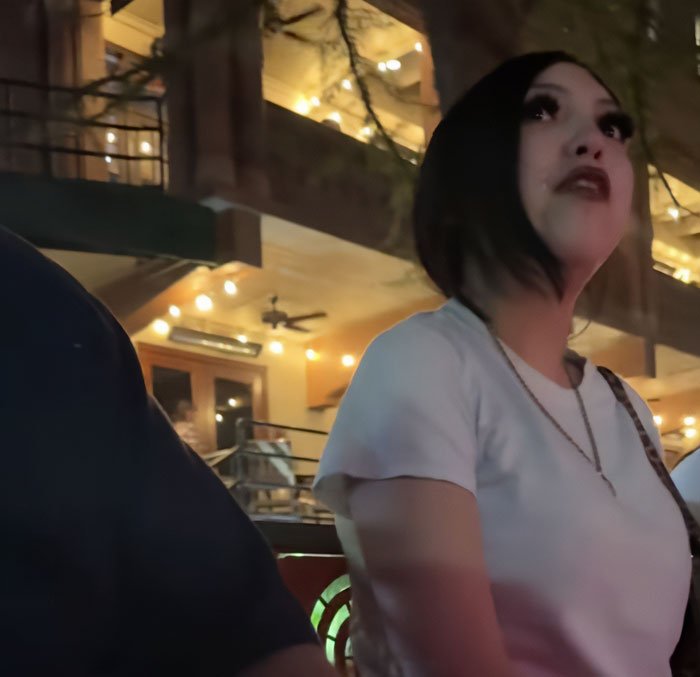 Teen taught harsh lesson by judge after pepper-spraying tourists on a boat, standing in dimly lit outdoor setting.