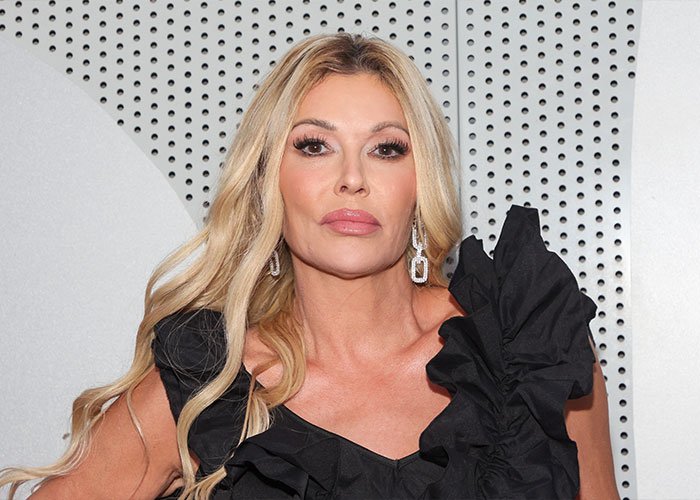 Brandi Glanville posing at event, showcasing bold look after face disfigurement diagnosis and psychosis on display.