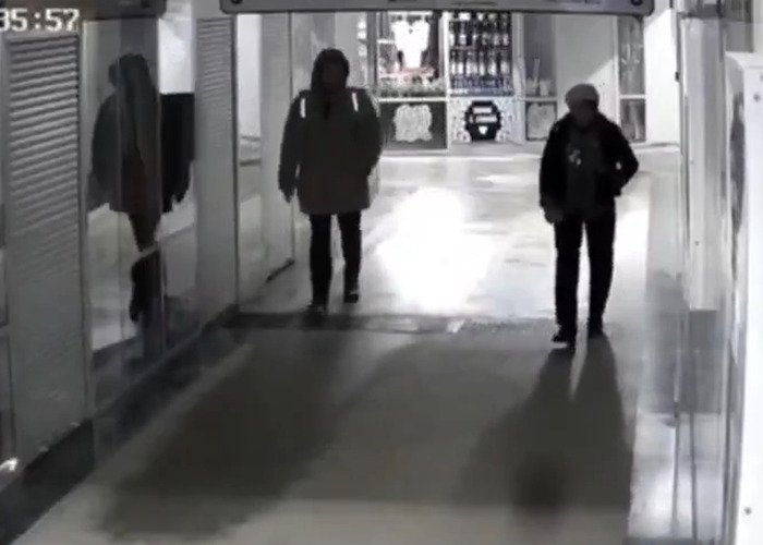 CCTV footage showing delivery man approaching woman in hallway before sudden violent attack in disturbing psychopath incident.