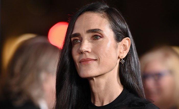 Jennifer Connelly attending an event, reflecting on her iconic movie scene and career regrets in a thoughtful expression.
