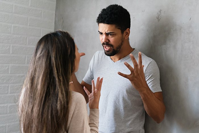 Woman and man arguing intensely, highlighting family intervention and obsession issues leading to hospitalization.