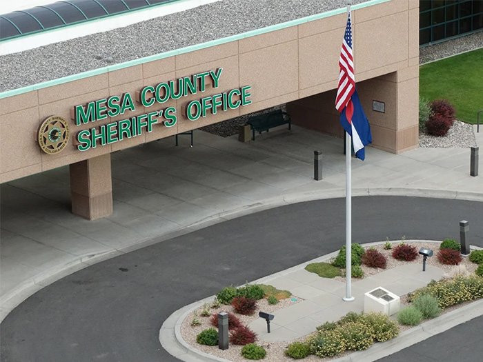 Mesa County Sheriff's Office building exterior with flagpole and landscaped walkway related to chilling 911 call incident.