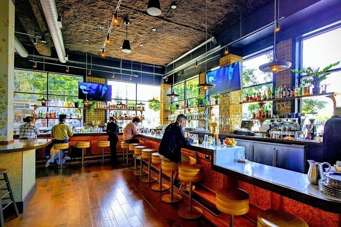 Upscale restaurant interior with patrons at the bar, related to Karen drunken rampage and tech executive exposure.
