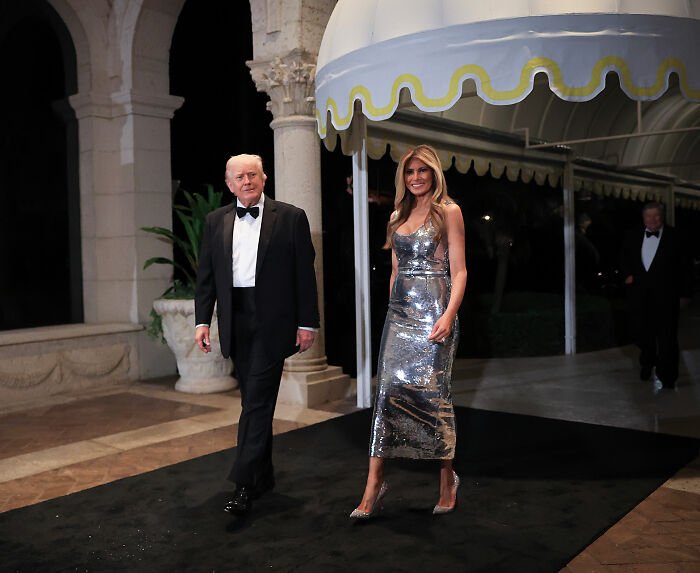 Melania Trump in a silver dress and Donald Trump in a tuxedo at Mar-a-Lago, highlighting body language and interaction.
