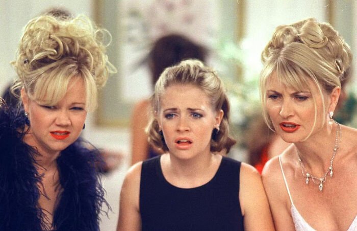 Nickelodeon star looking upset and crying with two women, highlighting humiliating moment shared with Britney Spears.