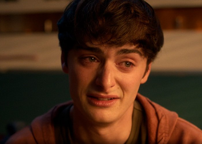 Noah Schnapp from Stranger Things looking emotional in a close-up scene related to Will Byers discussion.
