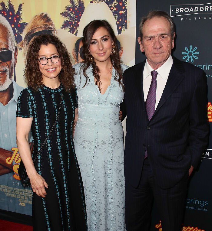 Tommy Lee Jones with two women at a red carpet event, related to joke about firing daughter Victoria.