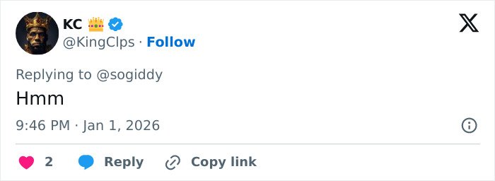 Tweet from verified user KC replying with hmm, showing profile photo of a man wearing a crown emoji and dark clothing.