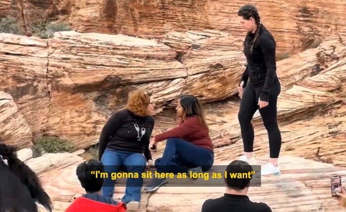 Woman blocks tourist’s shot at Red Rock Canyon while sitting on rocks, causing a viral Karen of 2026 incident.