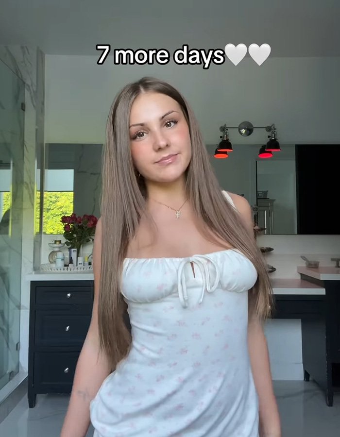 Teen influencer posing indoors with long hair and white dress, promoting app debut that nets $1M in first hour.