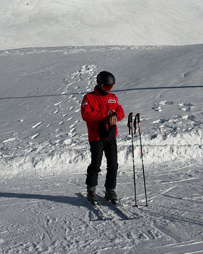 Pierre Gasly skiing on snowy slope in red jacket and black helmet amid Michael Schumacher tribute backlash in F1 context.