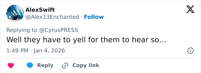 Tweet reply on social media discussing Miley Cyrus pushing back at photographers during tense red carpet encounter.