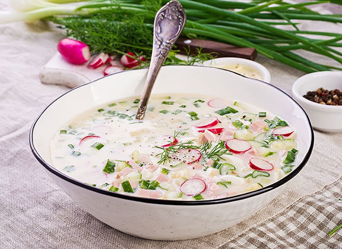 Traditional gross food in a bowl with radishes, cucumbers, and herbs, representing cultural dishes vs American dishes.