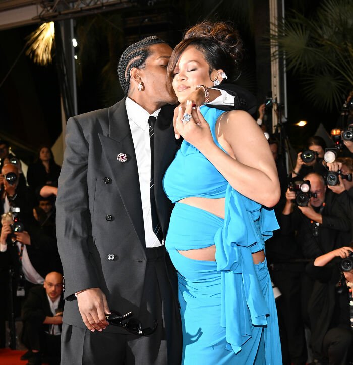 pregnant celebrity in blue gown kissed on red carpet amid distorted lingerie photos controversy