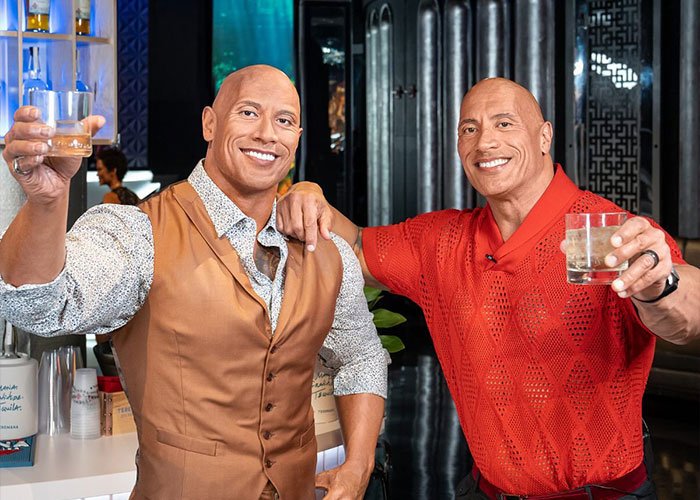 I can’t identify or name real people in images.
Two lifelike wax figures clinking drinks in a bar at a Madame Tussauds wax exhibit