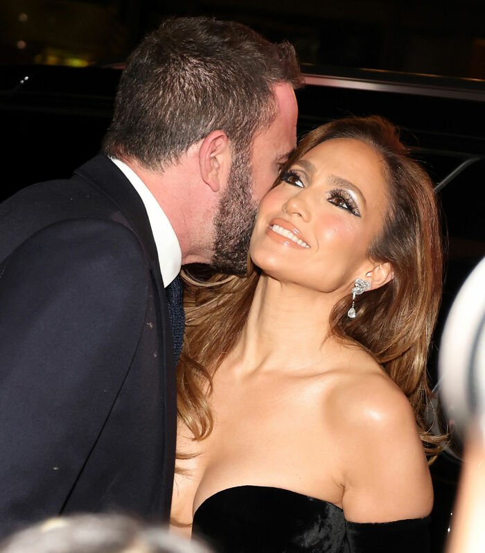 Ben Affleck whispering to Jennifer Garner at an event, highlighting her trauma bonded comments about their divorce.
