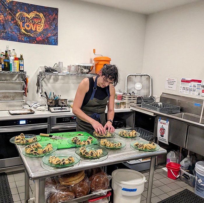 A chef preparing plated pastries in a commercial kitchen, related to coverage of trans chef controversy.