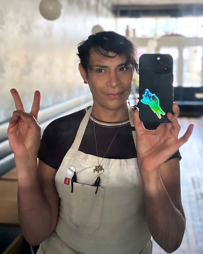 Trans chef taking a selfie in apron making peace sign, related to media coverage controversy and J.K. Rowling comments.