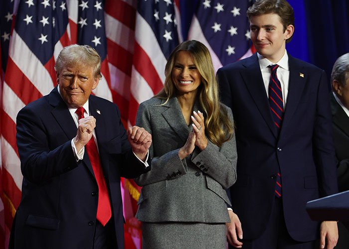 Donald Trump, Melania, and Barron Trump at an event with American flags, linked to Barron Trump marry Princess Isabella viral post.
