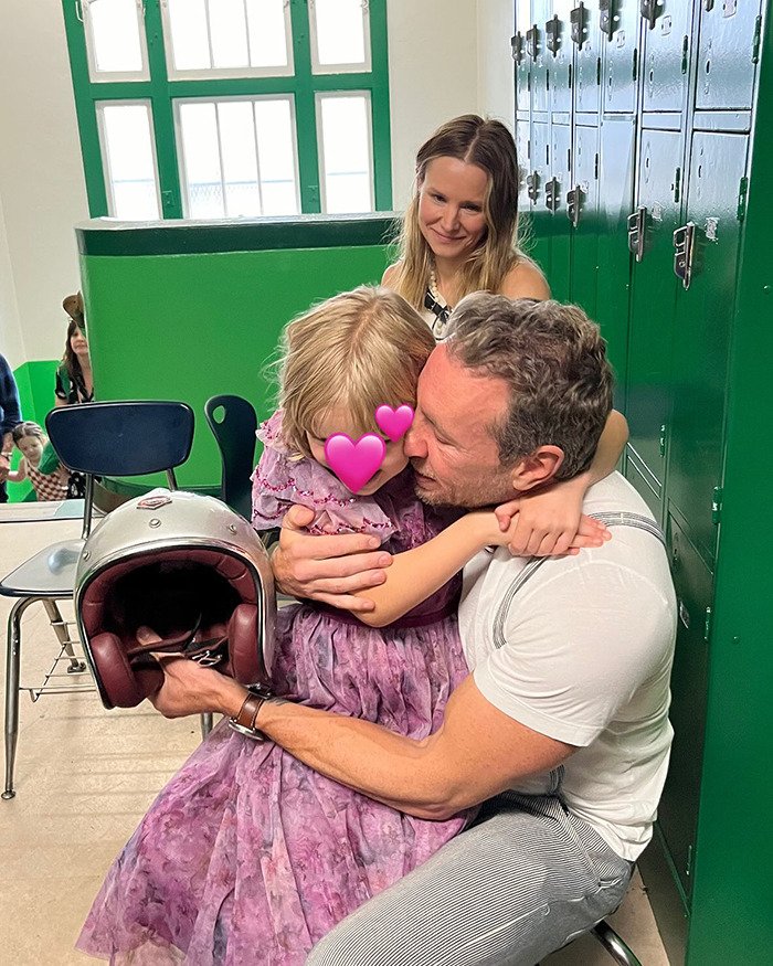 Dax Shepard hugging his young daughter in a school hallway, touching on talks about freezing eggs and parenting debates.