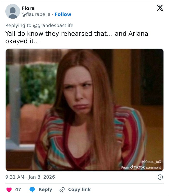 Woman with long red hair making an uncomfortable face related to Ariana Grande and Madonna performance backlash.
