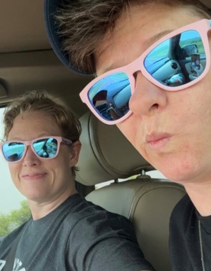 Two women wearing pink sunglasses sitting inside a car, related to Renee Good’s wife breaking silence on fatal ICE incident.