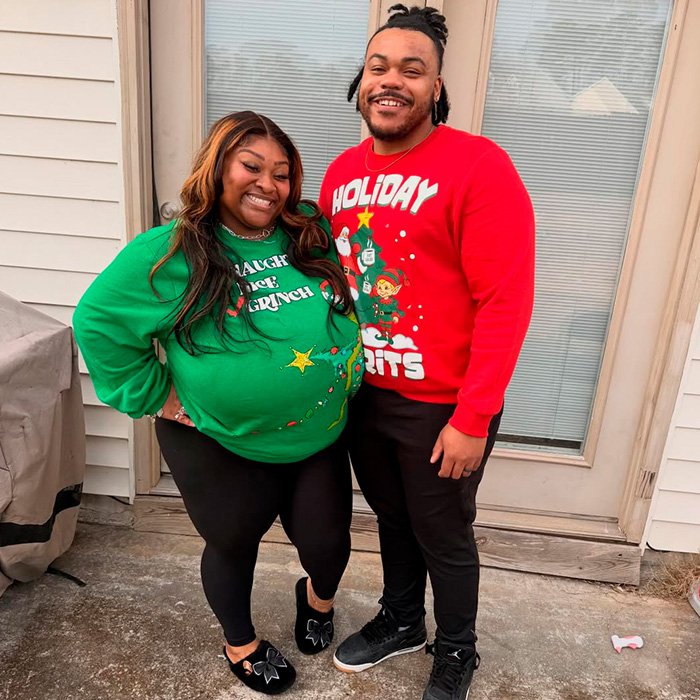 TikTok influencer and partner in festive sweaters standing outside a home, involved in a $1.75M legal case.