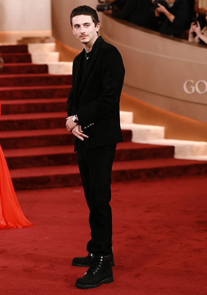 Timothée Chalamet on the red carpet at the Golden Globes amid snub rumors involving Kylie Jenner and other stars.