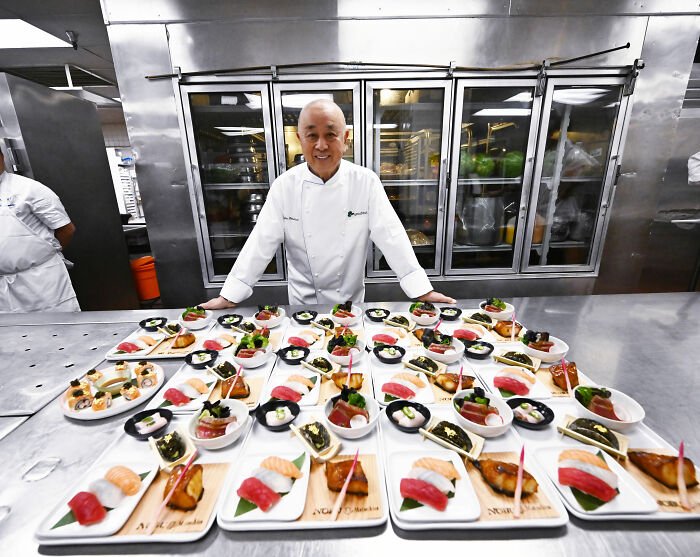 Chef presenting Golden Globes food dishes in a commercial kitchen, showcasing items available to order on DoorDash.