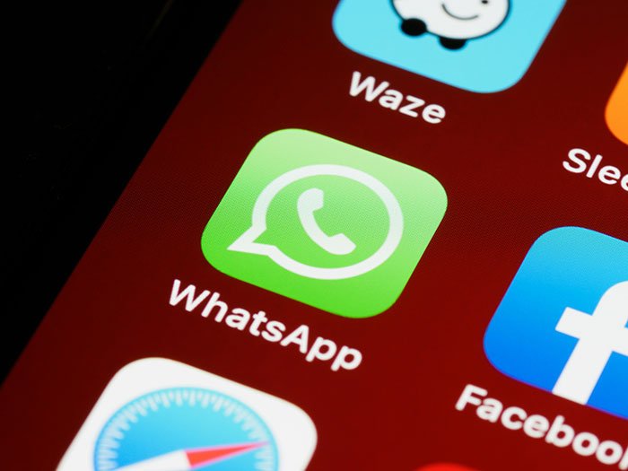 WhatsApp app icon on a smartphone screen, representing a guy getting emotionally invested in a family group chat.