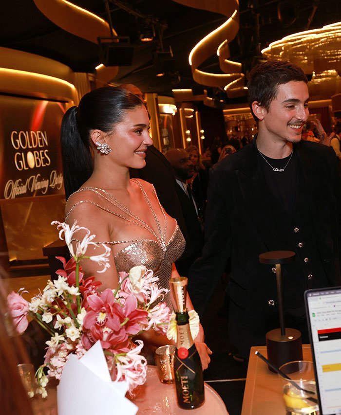 Timothée Chalamet with a woman at a Golden Globes event, highlighting their tension after fight exposure.