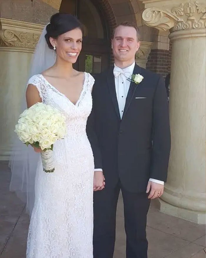 Bride and groom holding hands outside, related to ex FBI agent suggesting motive in Ohio dentist homicide case.