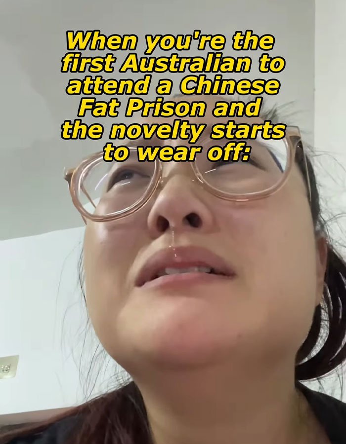 Close-up of a woman wearing glasses with a distressed expression describing conditions in a Chinese fat prison.