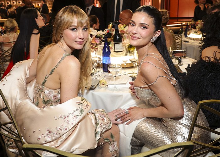 Kylie Jenner at Golden Globes event in a shimmering dress, sparking online debate over her unusual seat photo.