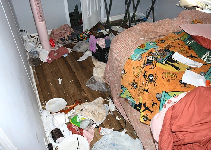 Cluttered and dirty mobile home interior showing evidence of neglect and abandonment in a horrific living situation.