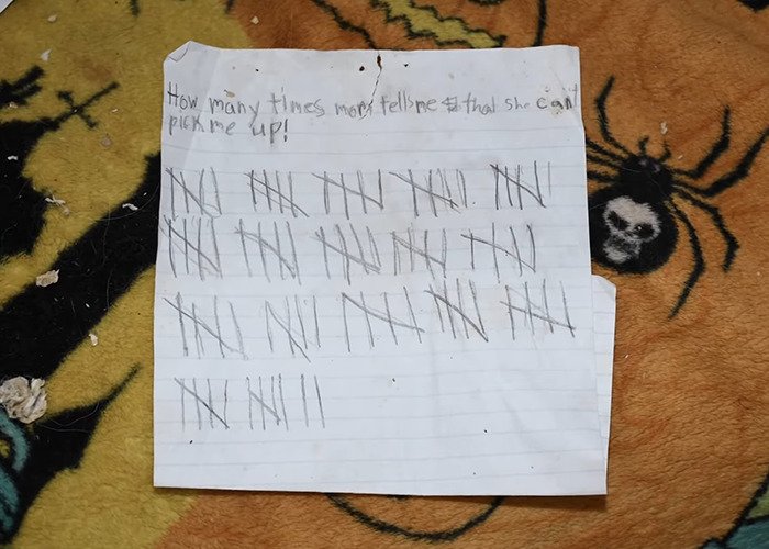 Handwritten note with tally marks showing time a girl abandoned in mobile home was not picked up, reflecting a horrific situation.
