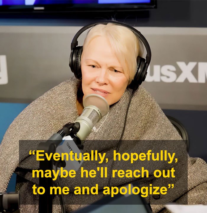 Pamela Anderson speaking in a radio studio wearing headphones, discussing apology from Seth Rogen after Golden Globes incident.