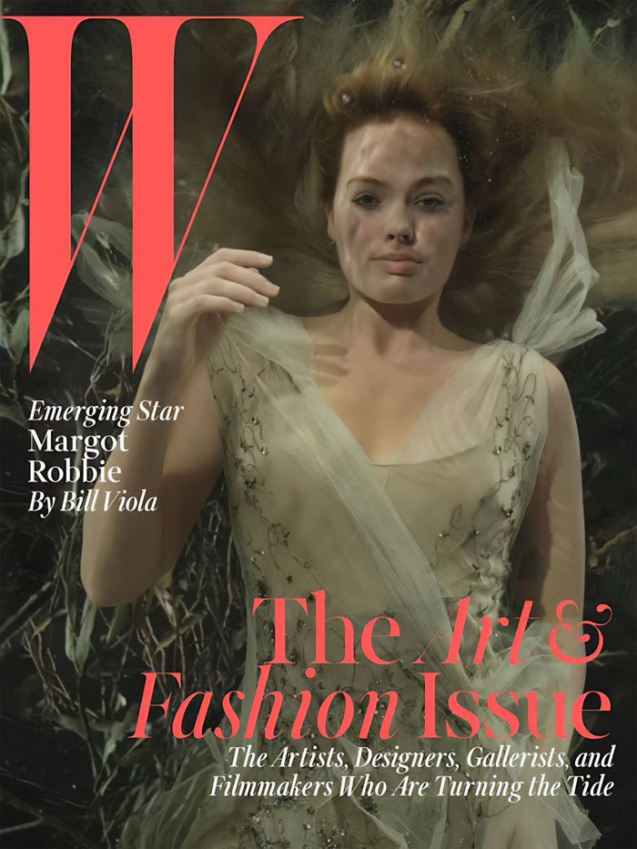 Margot Robbie underwater cover shoot in a flowing dress, featured in a fashion and art magazine issue.