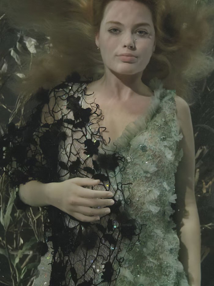 Margot Robbie in a detailed floral dress posed underwater for a controversial underwater cover shoot.