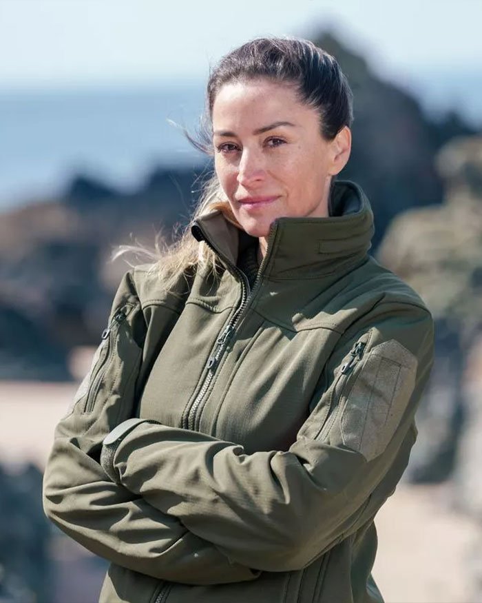 Woman in an olive green jacket outdoors, representing David Beckham’s ex-assistant reacting to Brooklyn Beckham’s family rift.
