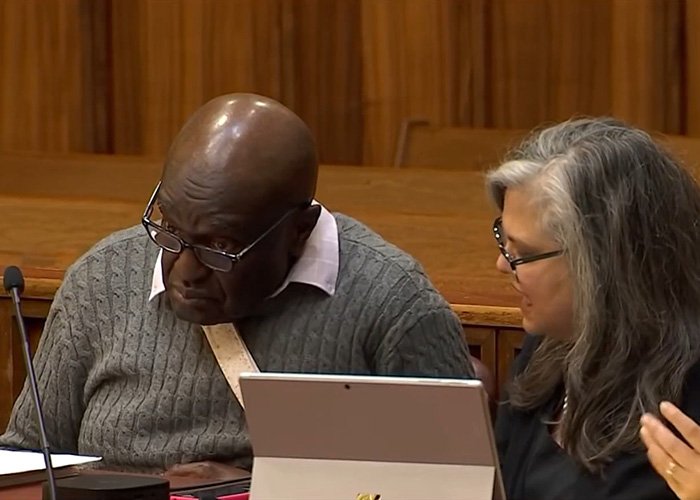 Two people in a courtroom setting reviewing documents related to a five-year-old’s chilling last words case.