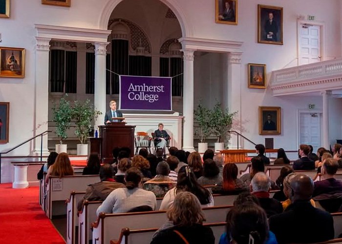Audience listening to a speaker at Amherst College during an event linked to the recent firing spree controversy.