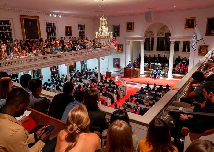 Audience attending Amherst College event in a historic hall as firing spree follows raunchy orientation backlash