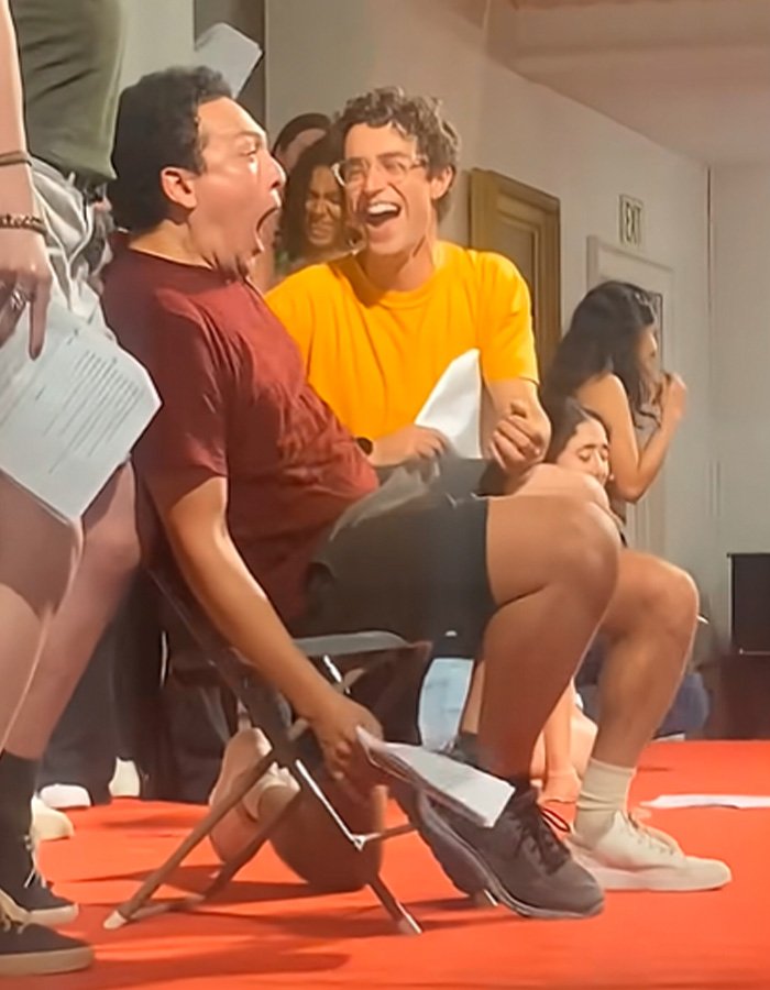 Group of students in casual clothing laughing and reacting dramatically during Amherst College raunchy orientation ceremony event.
