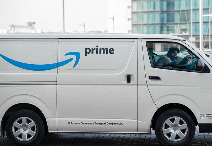 Delivery driver in a white van parked outside, depicting a man accidentally moving next door to former friend scenario.