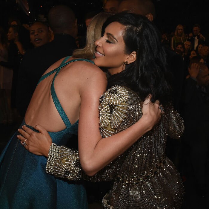 Kim Kardashian and Taylor Swift sharing a hug amid controversy and Blake Lively bombshell text reveal at an event.