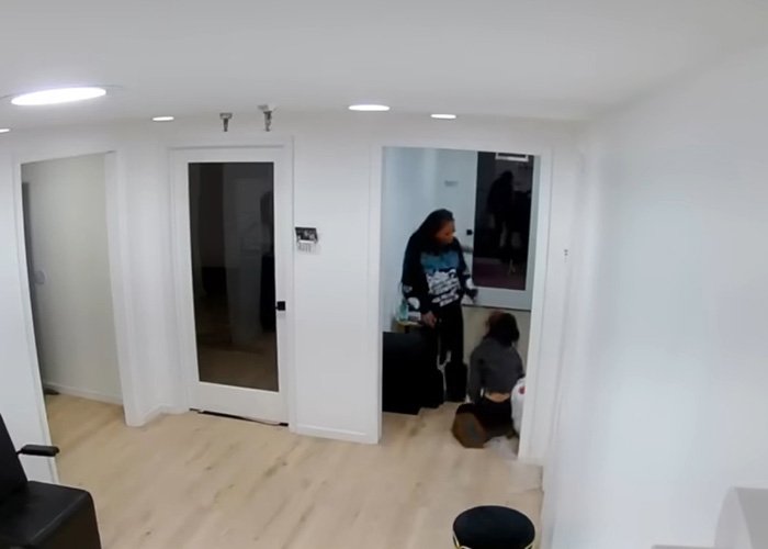 Maryland hairstylist drags teen client by hair in salon, captured in a viral video incident inside a white-walled room.