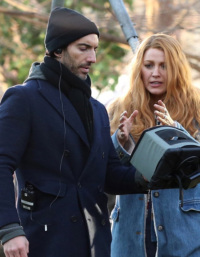 British actress Jameela Jamil in a winter coat and Blake Lively in denim jacket discussing on set outdoors.