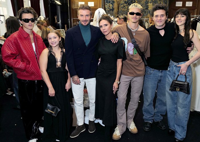Victoria Beckham and family posing at an event amid viral tense exchange and feud with Nicola Peltz.