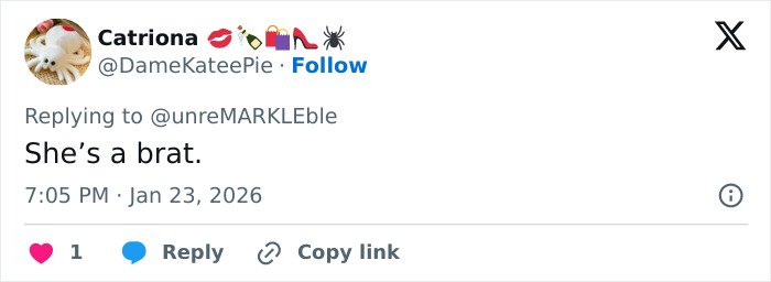 Screenshot of a tweet showing a reply reading she’s a brat amid Victoria Beckham and Nicola Peltz feud going viral.